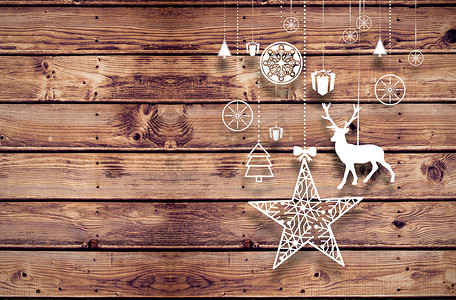悬挂木板摄影照片_悬挂圣诞装饰品的复合图像