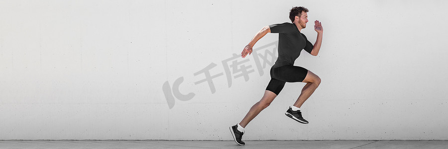 跑步男子跑步训练进行户外城市跑步沿着墙壁背景冲刺。