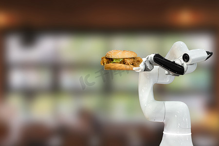 餐厅里拿着汉堡的智能机器人食品未来机器人自动化提高了效率