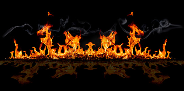 热摄影照片_在黑色背景的火焰上，燃烧着红热的火花
