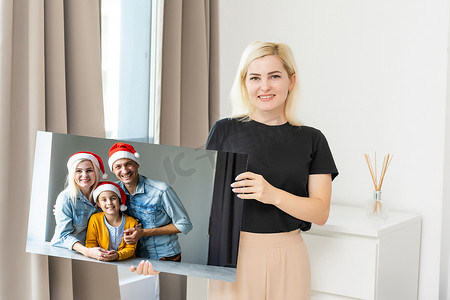 女人拿着一张印有圣诞节照片的画布