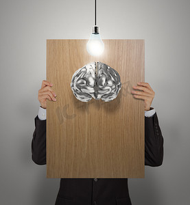 公司海报摄影照片_商人手展示 3D 金属大脑的木制海报作为概念