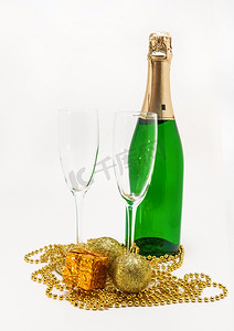 一瓶香槟、眼镜和圣诞金色装饰品 isol