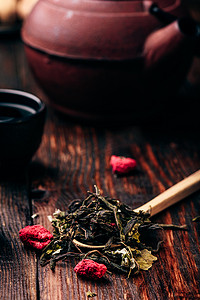 黑色覆盆子摄影照片_有茶壶的茶碗和一勺覆盆子清凉茶