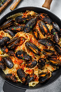 马尔福摄影照片_传统的意大利海鲜意大利面配贻贝、意大利面和番茄酱。