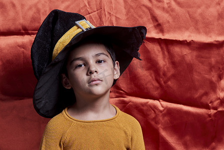万圣节小孩摄影照片_一个戴着女巫帽子的小孩