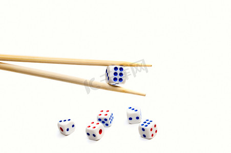 白色背景上的筷子和骰子
