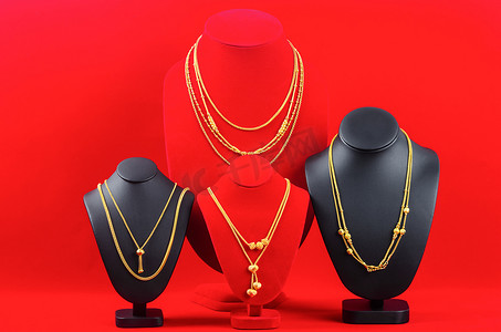 配件和黄金首饰项链展示架，红色天鹅绒面料上配有金项链。