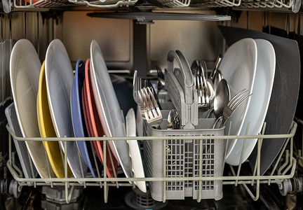 器皿摄影照片_开放式洗碗机，配有干净的盘子、器皿和锅