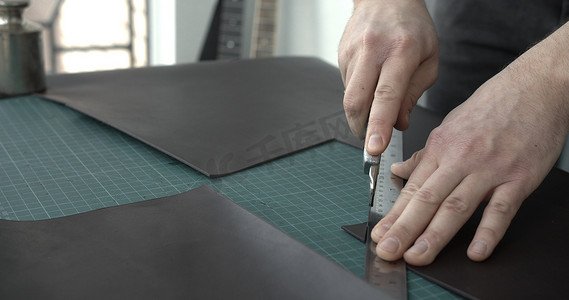 在皮革车间制作新型手工皮革钱包的工作过程。