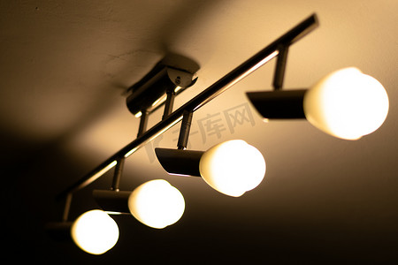 实惠摄影照片_一些温暖的灯泡安装在房子的天花板上 — 电力和照明概念，罗马尼亚布加勒斯特