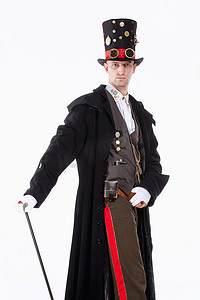 魔术师摄影照片_带高帽、长外套和时钟零件的魔术师细节
