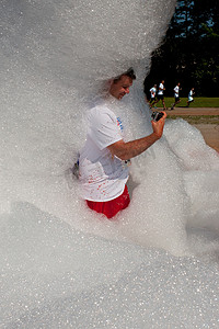 一名男子站在 Bubble Palooza 的肥皂水中自拍