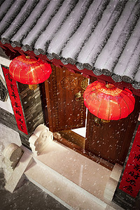 挂着的灯笼摄影照片_雪中的挂着红灯笼的中式庭院