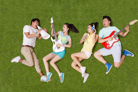 青年男女躺在草地上弹吉他