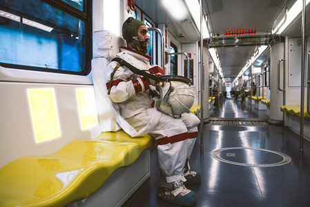 太空人在一个未来派的空间站。穿宇航服的人去上班，坐火车去了