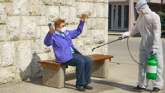 CLOSE UP: Woman gets scared while being sprayed with chemicals by virologist.