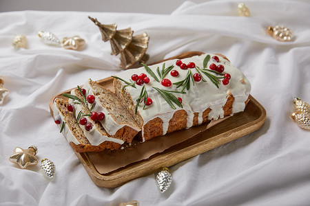 白布摄影照片_传统的圣诞蛋糕，木板上有覆盆子，白布上有覆盆子