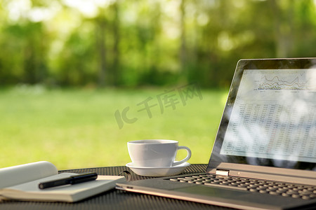 Laptop and coffee in outdoor office