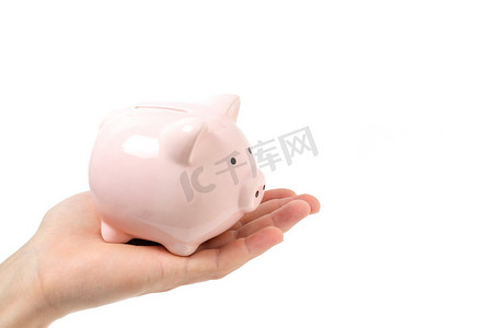 粉红小猪摄影照片_在手掌上的粉红小猪银行。白色背景.