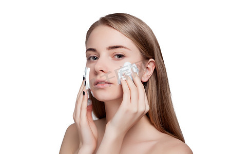 美丽的女人洗脸用泡沫治疗光背景