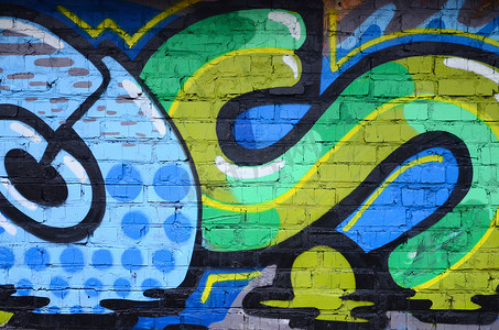 涂鸦画碎片。在街头艺术文化的风格上装饰着漆渍的旧墙。彩色背景纹理.