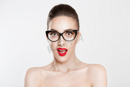 Wow. Shocked surprised stunned. Close up portrait young woman beautiful girl with brunette brown hair looking excited holding her mouth opened, isolated white light grey wall. Positive human emotion