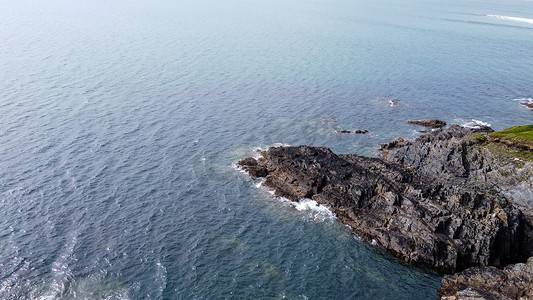 一个巨大的石头斗篷在大西洋的水域，顶部的视野。平静的海面海景空中照片.