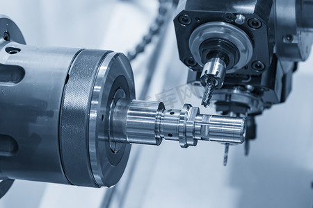 processing摄影照片_The multi tasking CNC lathe machine in metal working process.