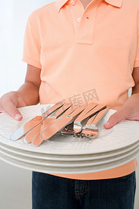 男孩拿着盘子和餐具