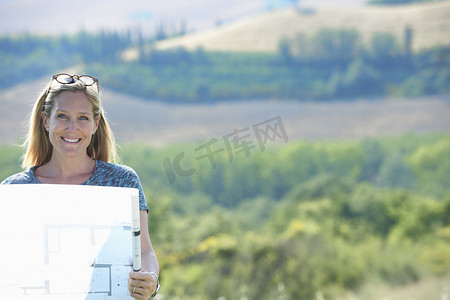 站在山上看建筑师平面图的成熟女性