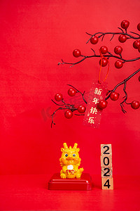 春节背景摄影照片_新年春节2024红色背景上摆放摄影图配图