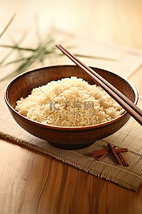 桌子上放着一个装有米饭和筷子的碗