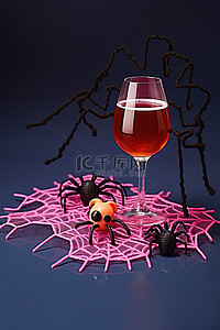 蜘蛛背景图片_玻璃杯上的塑料钩针蜘蛛，上面有酒