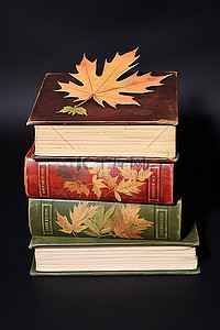 秋天剪纸背景图片_白色背景上堆放着叶子剪纸的三本书