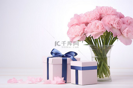母亲节背景图片_两个礼盒和一朵粉色康乃馨