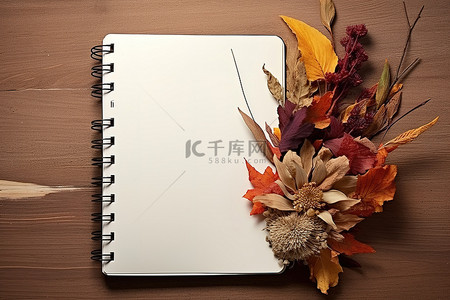木质表面有花和叶的秋季笔记本