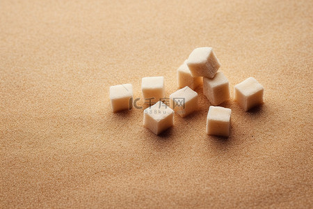 福利背景图片_作为背景放置在沙子上的糖块