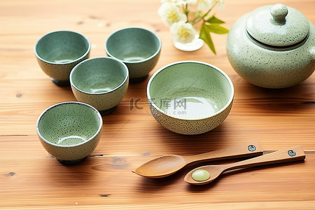 木桌上的小碗，包括绿茶和勺子