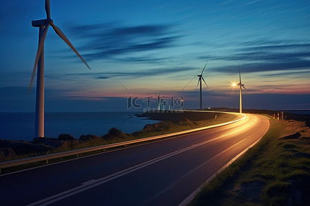 夜景天空背景图片_日落时风力涡轮机附近的道路