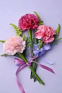 教师节背景图片_三朵粉色康乃馨，绿叶和丝带