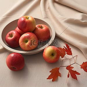 苹果放在布桌上，旁边有叶子