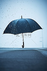 雨伞背景图片_雨伞溅到寒冷表面的图像