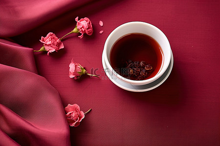 枸杞背景图片_一杯茶放在一块粉红色的布上
