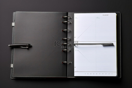 每周上新背景图片_灰色表面上的每周笔记本日历和办公桌记事本