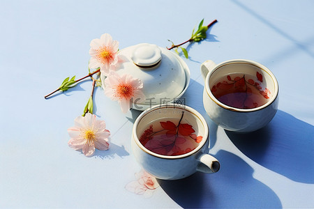 杯茶背景图片_蓝色桌面上的两杯茶和鲜花