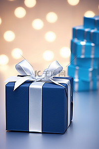 生日对折贺卡背景图片_礼品包装旁边的蓝色生日贺卡