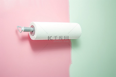 粉色和白色墙壁上滚动的白色油漆滚筒