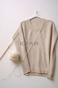 冬天背景图片_一件毛衣，里面有纱线和一些织针