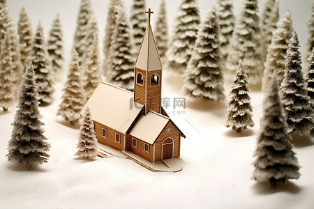 雪上一座小型模型教堂的冬季景观图像